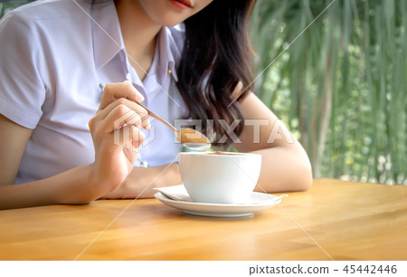 hand hold spoon to mix hot coffee foam on cup hand hold spoon to mix hot coffee foam on cup 45442446