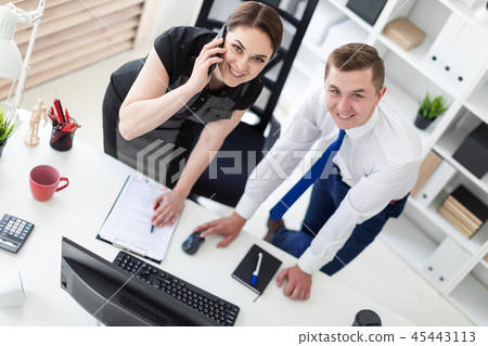 Young people in the office looking at the monitor. 45443113