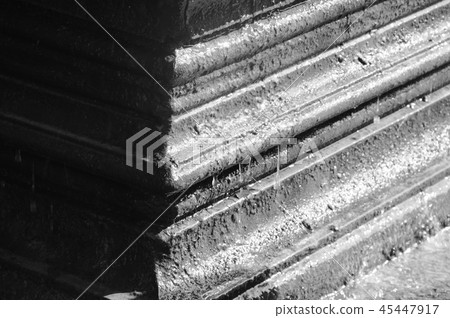 water dropping from cement pole background 45447917