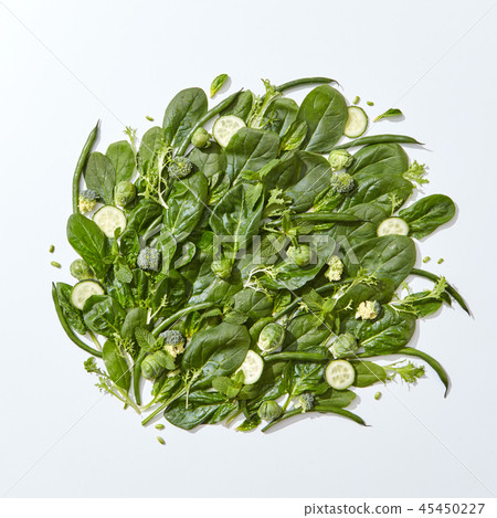 Composition of fresh green spinach vegetables, cucumber slices, mint leaves, asparagus and cabbage 45450227