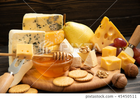 Various types of cheese on a rustic table Various types of cheese on a rustic table 45450511