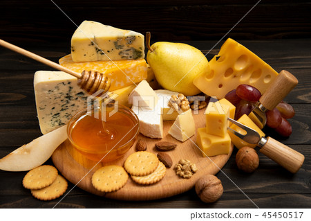 Various types of cheese on a rustic table Various types of cheese on a rustic table 45450517