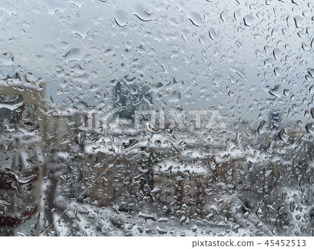 drops on window against city view under snow 45452513