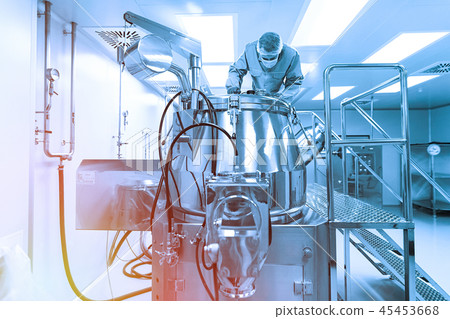 scientist look in steel tank in laboratory. Blue tone. Blue tint scientist look in steel tank in laboratory. Blue tone. Blue tint 45453668