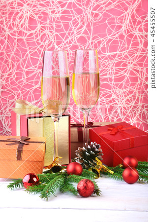 New Year or Christmas decorations with glasses wine, gift boxes, candles and balls. greeting card New Year or Christmas decorations with glasses wine, gift boxes, candles and balls. greeting card 45455507
