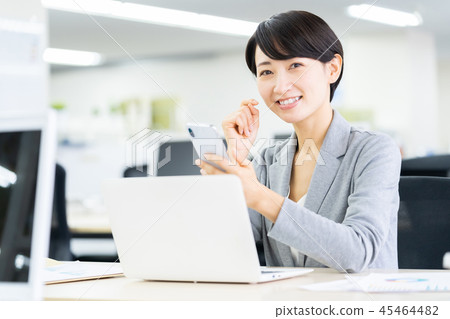 Business woman operating a smartphone Female employee Female office worker Office image Business image 45464482