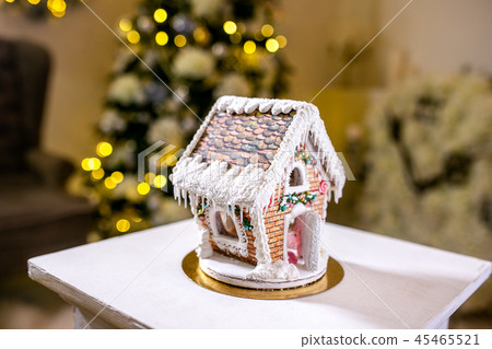 Gingerbread house in front of defocused lights Gingerbread house in front of defocused lights 45465521