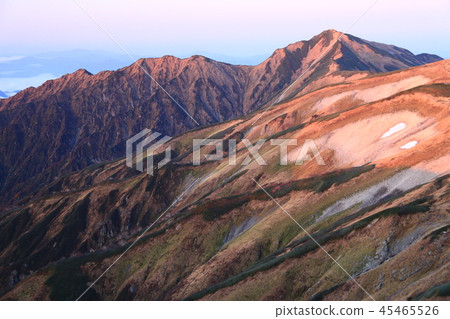 A view of Mt. Dainichi that shines in the morning sun of the Honyama hut just below the summit of the Mt. A view of Mt. Dainichi that shines in the morning sun of the Honyama hut just below the summit of the Mt. 45465526