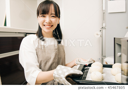Young housewife Japanese woman opening bread making oven 45467805