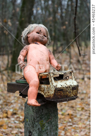 Doll and rusty car near abandoned kindergarten 45468237