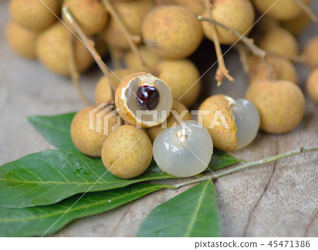 Fresh longan isolated on wooden background 45471386