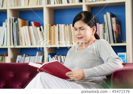 Aged woman reading book 45471576