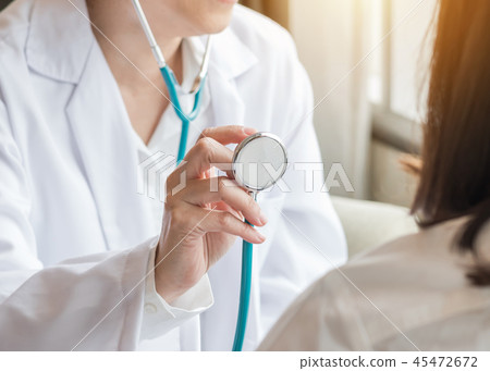 Cardiologist doctor examining woman patient heart Cardiologist doctor examining woman patient heart 45472672