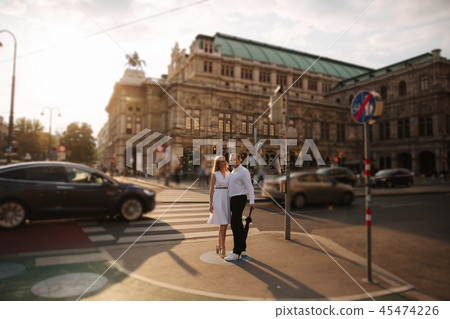 Lovely couple walking around the city. During the summer. Evening time sunset in city 45474226