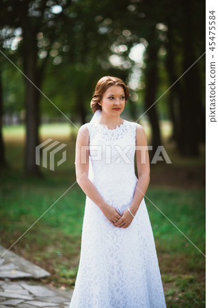 portrait of a young bride on the background park 45475584