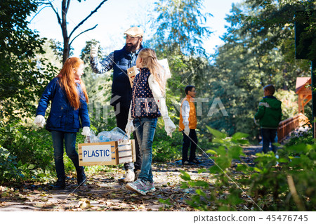 Nice pleasant girls holding a heavy box 45476745