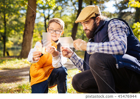 Positive serious father and son taking beautiful photos 45476944