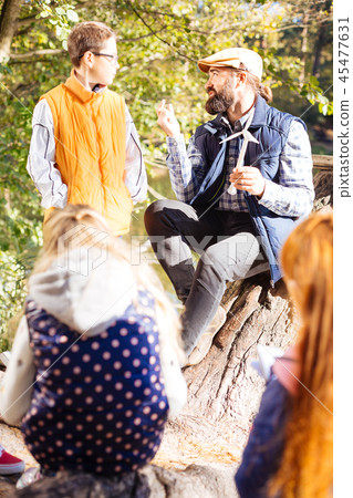 Smart educated man telling a boy about eco energy Smart educated man telling a boy about eco energy 45477631