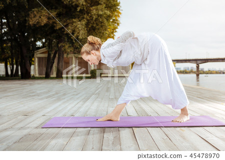 Woman doing yoga exercises for strengthening her muscles Woman doing yoga exercises for strengthening her muscles 45478970