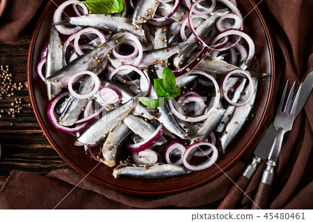 salted sprats on a clay plate salted sprats on a clay plate 45480461