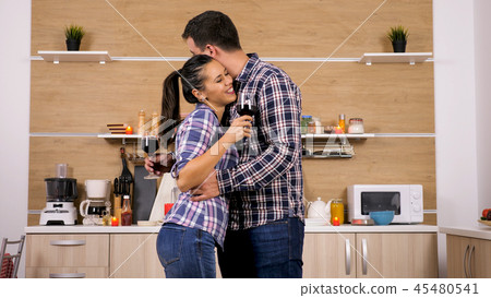Young happy couple enjoy some great red wine Young happy couple enjoy some great red wine 45480541