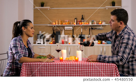 Sweet couple having a romantic dinner at home Sweet couple having a romantic dinner at home 45480550
