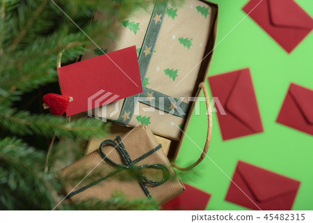 Paper bag with gifts under Christmas tree 45482315