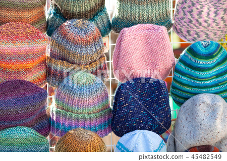 A lot of knitted hats. 45482549