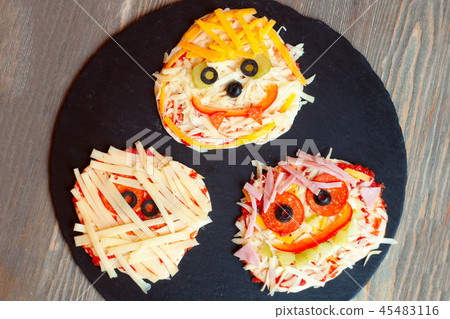 Raw Halloween pizza with monsters Raw Halloween pizza with monsters 45483116