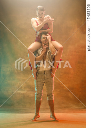 Flexible young modern dance couple posing in studio. 45483506