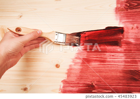 Hand painting red color on wooden table 45483923