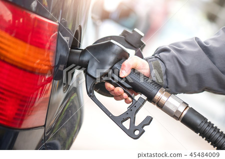 Gasoline pump during supply to a car 45484009