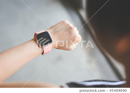 Woman checking smartwatch Woman checking smartwatch 45484690