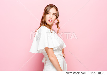 Suspiciont. Doubtful pensive woman with thoughtful expression making choice against pink background Suspiciont. Doubtful pensive woman with thoughtful expression making choice against pink background 45484835