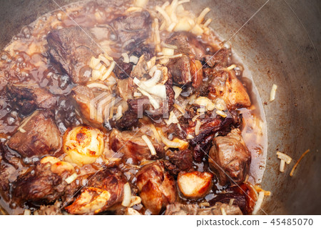 Lamb and vegetables boil in a cauldron Lamb and vegetables boil in a cauldron 45485070