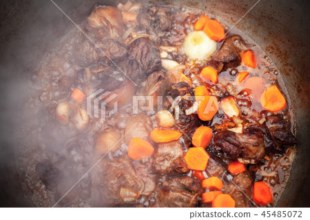 Lamb with vegetables stew in a cauldron Lamb with vegetables stew in a cauldron 45485072