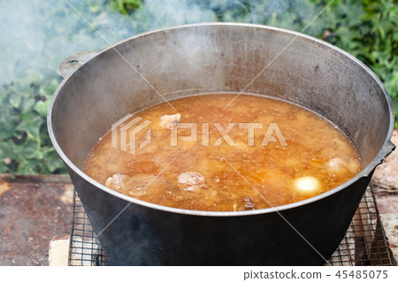 Broth with lamb and vegetables in big pan Broth with lamb and vegetables in big pan 45485075