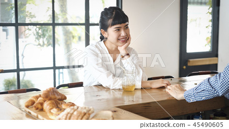 A woman relaxing at a cafe A woman relaxing at a cafe 45490605