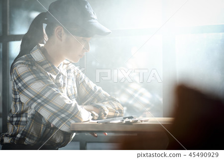 A woman relaxing at a cafe 45490929