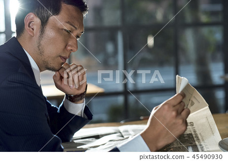 Businessman relaxing in a cafe Businessman relaxing in a cafe 45490930