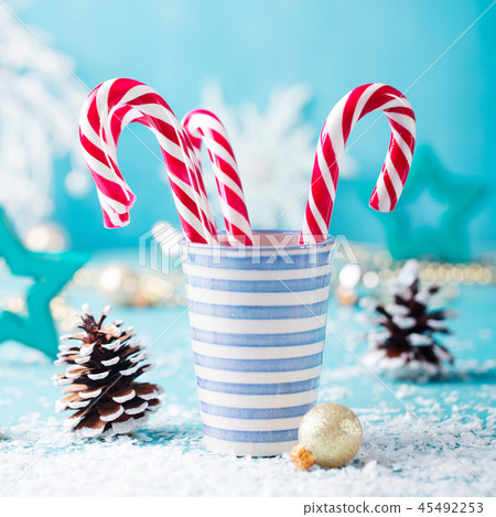 Candy cane sweets in a mug. Christmas and New Year background. Close up. 45492253