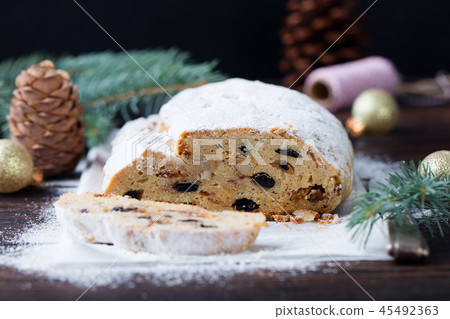 Christmas stollen cake with icing sugar. Traditional Dresdner christ pastry. Close up. Christmas stollen cake with icing sugar. Traditional Dresdner christ pastry. Close up. 45492363