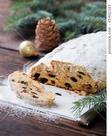 Christmas stollen cake with icing sugar. Traditional Dresdner christ pastry. Copy space. Christmas stollen cake with icing sugar. Traditional Dresdner christ pastry. Copy space. 45492383