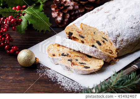 Christmas stollen. Traditional German festive dessert. Wooden background. Copy space. Christmas stollen. Traditional German festive dessert. Wooden background. Copy space. 45492407