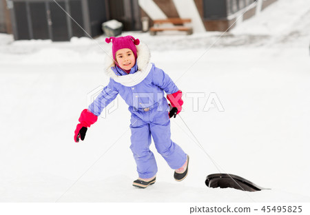 little girl with sleds on snow hill in winter little girl with sleds on snow hill in winter 45495825