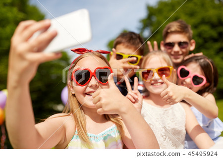 kids taking selfie and showing thumbs up at park kids taking selfie and showing thumbs up at park 45495924