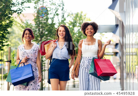 happy women with shopping bags walking in city happy women with shopping bags walking in city 45495928