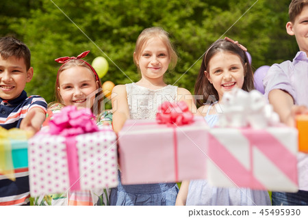 happy kids with gifts on birthday party in summer 45495930