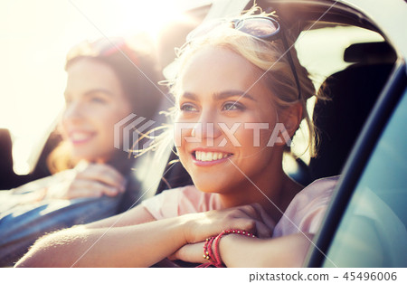 happy teenage girls or women in car at seaside happy teenage girls or women in car at seaside 45496006