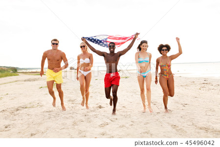happy friends with american flag on summer beach happy friends with american flag on summer beach 45496042